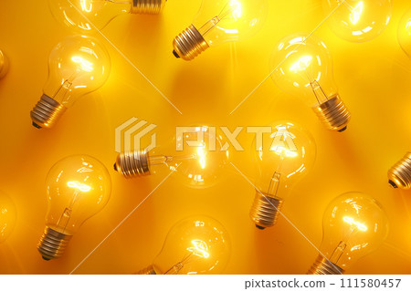 Light bulbs on yellow background, creative pattern. Light, technology, idea concept. Glowing light bulbs Light bulbs on yellow background, creative pattern. Light, technology, idea concept. Glowing light bulbs 111580457