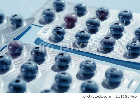 Blister with blueberries as pills. Berries instead of tablets. Natural Vitamin C supplement. Immune system boost. Tablets, pharmacy, medicine, vitamins. Health and medicine, sports nutrition concept 111580460