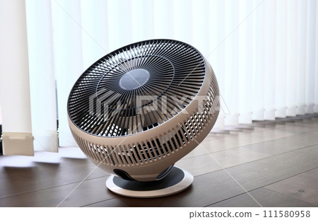 Circulator placed by the window of the room 111580958