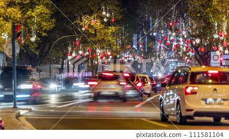 Avenida da Liberdade in Lisbon illuminated with lights hanging from the trees night timelapse. Portugal Avenida da Liberdade in Lisbon illuminated with lights hanging from the trees night timelapse. Portugal 111581104