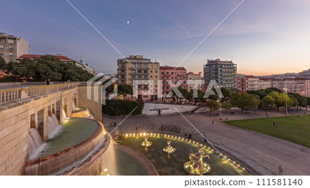 Panorama showing lawn at Alameda Dom Afonso Henriques and the Luminous Fountain aerial day to night timelapse in Lisbon. Panorama showing lawn at Alameda Dom Afonso Henriques and the Luminous Fountain aerial day to night timelapse in Lisbon. 111581140