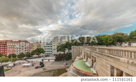 Panorama showing aerial view of Jardim da Alameda in Lisbon with the Luminous Fountain timelapse during sunset. Panorama showing aerial view of Jardim da Alameda in Lisbon with the Luminous Fountain timelapse during sunset. 111581161