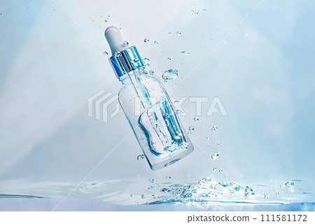 Cosmetic essence in a glass bottle with a pipette in a transparent liquid, water with bubbles. Concept of natural Hydration cosmetics, skin care serum. Scientific developments of modern cosmetics 111581172