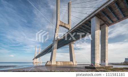 Vasco da Gama bridge timelapse hyperlapse with water in river and blue cloudy sky. Lisbon, Portugal. Vasco da Gama bridge timelapse hyperlapse with water in river and blue cloudy sky. Lisbon, Portugal. 111581181