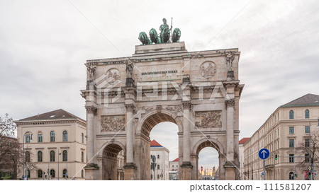 The Siegestor or Victory Gate in Munich is a memorial arch, crowned with a statue of Bavaria with a lion quadriga timelapse. Germany 111581207