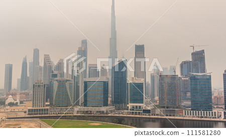 Aerial view to Dubai Business Bay and Downtown with the various skyscrapers and towers timelapse 111581280