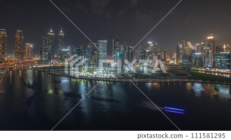 Panorama showing aerial view to Dubai Business Bay and Downtown with the various skyscrapers and towers night timelapse 111581295