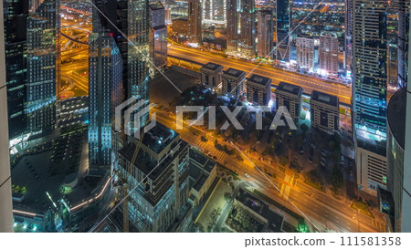 High-rise buildings on Sheikh Zayed Road in Dubai aerial all night timelapse, UAE. 111581358