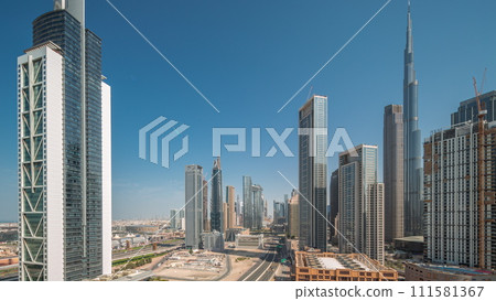 Aerial sunrise view of Dubai Downtown skyline with many towers night to day timelapse. Aerial sunrise view of Dubai Downtown skyline with many towers night to day timelapse. 111581367