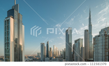Aerial sunrise view of Dubai Downtown skyline with many towers night to day timelapse. 111581370
