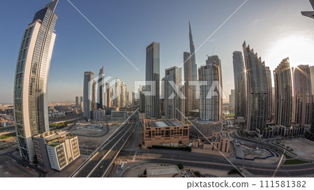 Aerial panorama of Dubai Downtown skyline with many towers night to day timelapse. 111581382
