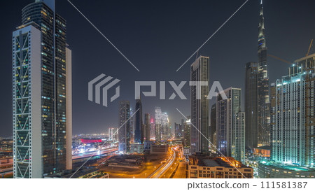 Aerial view of Dubai Downtown skyline with many towers day to night timelapse. Aerial view of Dubai Downtown skyline with many towers day to night timelapse. 111581387
