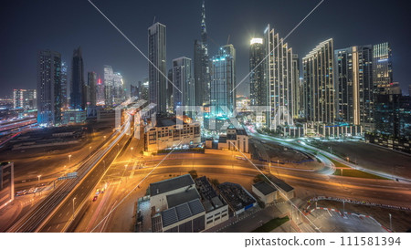 Aerial view of Dubai Downtown skyline with many towers day to night timelapse. 111581394