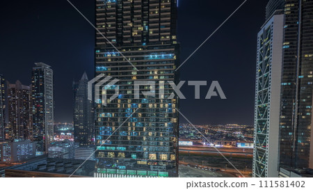 Aerial view of Dubai Downtown skyline with many towers night timelapse. Aerial view of Dubai Downtown skyline with many towers night timelapse. 111581402