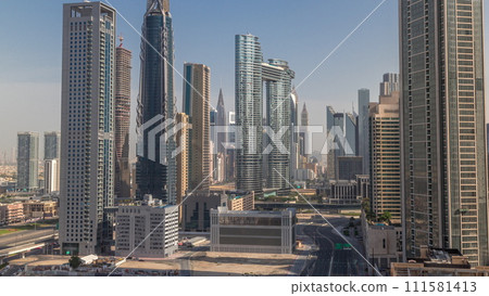 Many towers and skyscrapers with traffic on streets in Dubai Downtown and financial district morning timelapse. 111581413