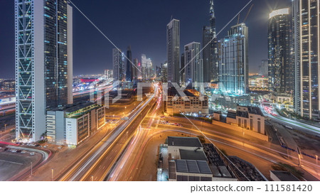 Aerial panoramic view of Dubai Downtown skyline with many towers day to night timelapse. 111581420