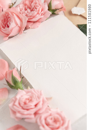 Blank card near light pink roses and petals close up, wedding mockup, copy space 111581980