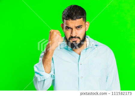 Aggressive angry Indian man trying to fight at camera, shaking fist, boxing, punishment, threaten Aggressive angry Indian man trying to fight at camera, shaking fist, boxing, punishment, threaten 111582173