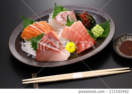 Assorted sashimi. Tuna, medium fatty tuna, salmon, yellowtail, and sea bream. Traditional Japanese cuisine. Assorted sashimi. Tuna, medium fatty tuna, salmon, yellowtail, and sea bream. Traditional Japanese cuisine. 111583402