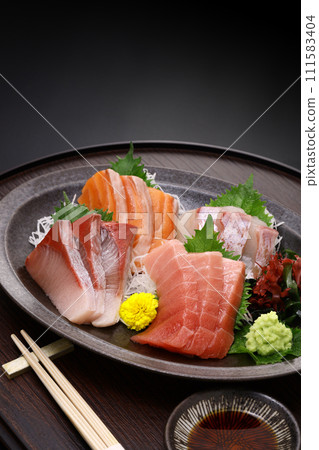 Assorted sashimi. Tuna, medium fatty tuna, salmon, yellowtail, and sea bream. Traditional Japanese cuisine. 111583404