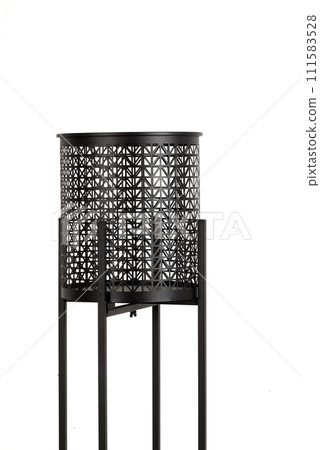 Black tall metal openwork planter on a stand, flower pot isolated Black tall metal openwork planter on a stand, flower pot isolated 111583528