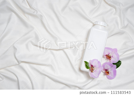 Floral scented laundry detergent on satin fabric top view, copy space for text 111583543