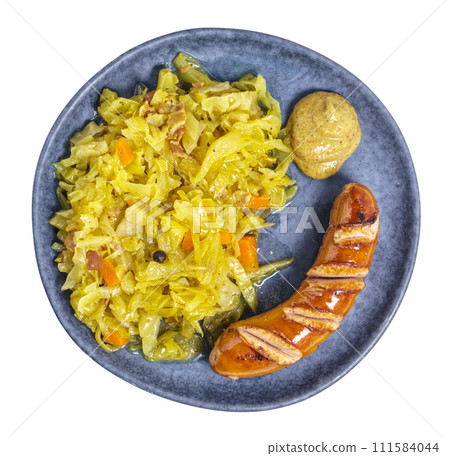 Braised cabbage with wiener and mustard on plate above, isolated 111584044