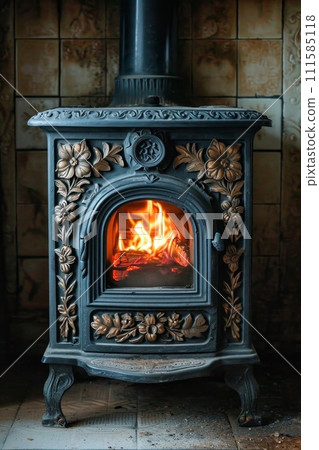cast-iron stove in a rustic house with a fire lit inside to heat the house 111585118