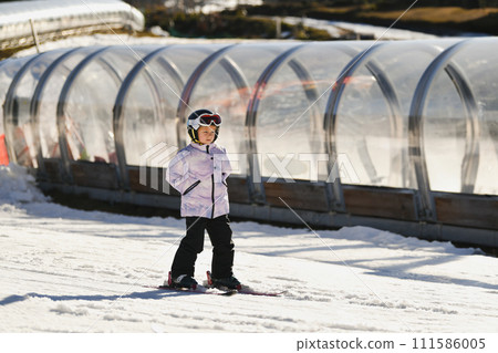 A six-year-old girl learns to ski A six-year-old girl learns to ski 111586005