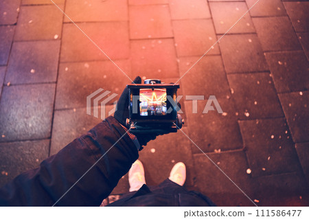 Looking through viewfinder of vintage TLR Camera 111586477