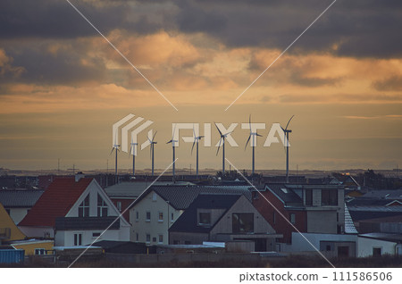 Wind energy next to village in denmark 111586506
