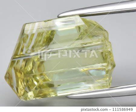 natural yellow tanzanite rough gem on the background natural yellow tanzanite rough gem on the background 111586949