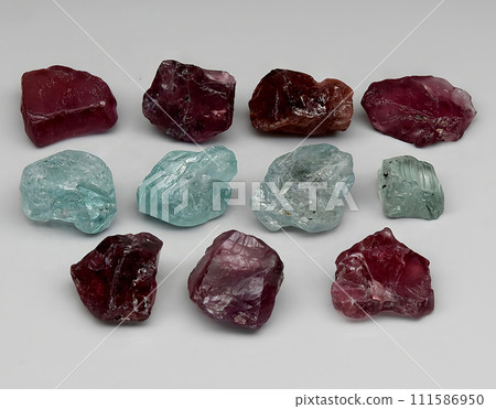 natural red garnet and zircon rough gem on the background natural red garnet and zircon rough gem on the background 111586950