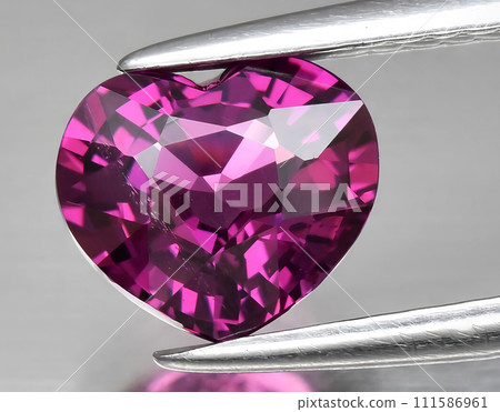 natural pink purple rhodolite garnet gem on the background natural pink purple rhodolite garnet gem on the background 111586961