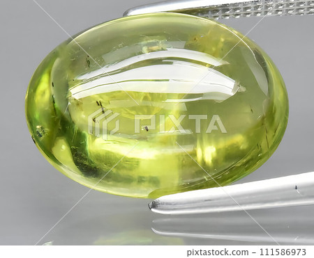 natural green peridot olivine gem on the background 111586973