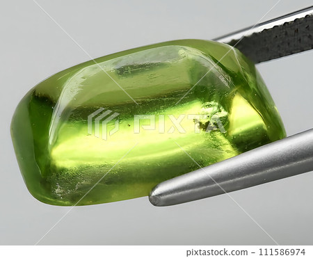 natural green peridot olivine gem on the background 111586974