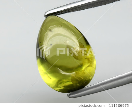 natural green peridot olivine gem on the background 111586975