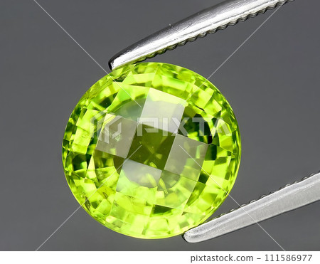 natural green peridot olivine gem on the background natural green peridot olivine gem on the background 111586977