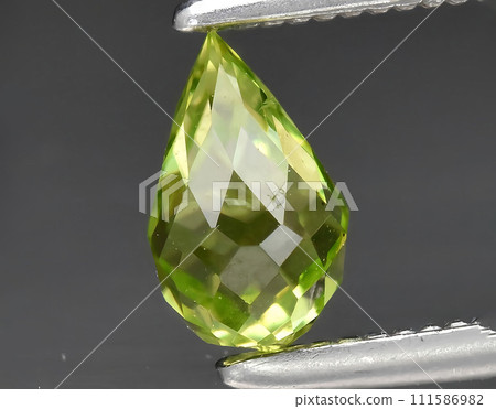 natural green peridot olivine gem on the background natural green peridot olivine gem on the background 111586982