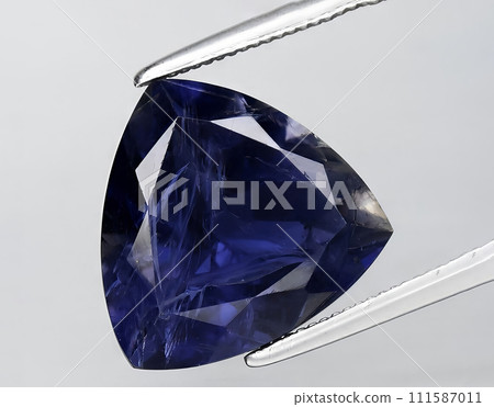 natural blue violet iolite gem on the background natural blue violet iolite gem on the background 111587011