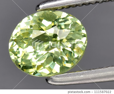 natural yellow green grossular garnet gem on the background 111587022