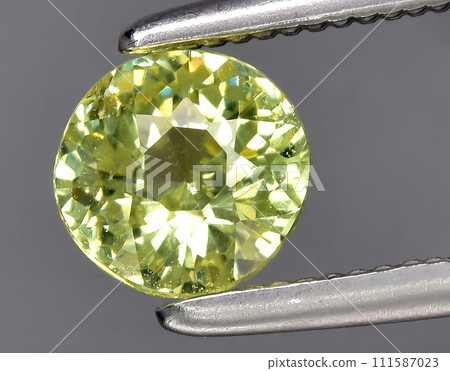 natural yellow green grossular garnet gem on the background 111587023