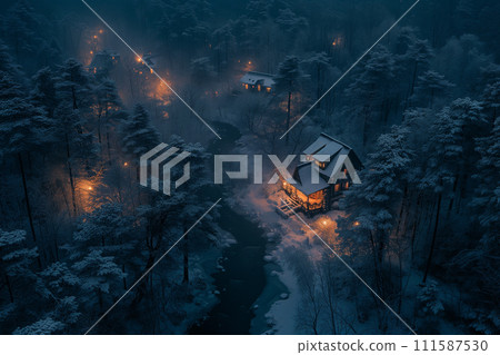 Cozy, warmly lit cabin nestled in a snow-covered forest, with gentle lights piercing the twilight ambiance. 111587530