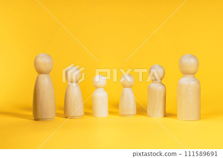 Family people figures on yellow background. Concept of family, values, unity, togetherness Family people figures on yellow background. Concept of family, values, unity, togetherness 111589691