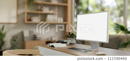 A modern Scandinavian CEO's office or home office with a computer mockup on a wooden table. 111590460