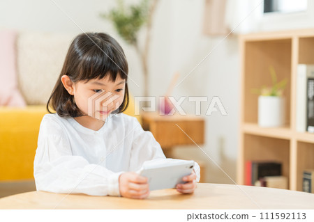 操作智慧型手機的小學生。 111592113