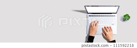 Person using a laptop computer 111592218