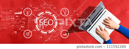 SEO concept with person using a laptop SEO concept with person using a laptop 111592260