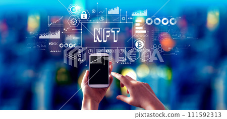 NFT theme with person using a smartphone at night NFT theme with person using a smartphone at night 111592313