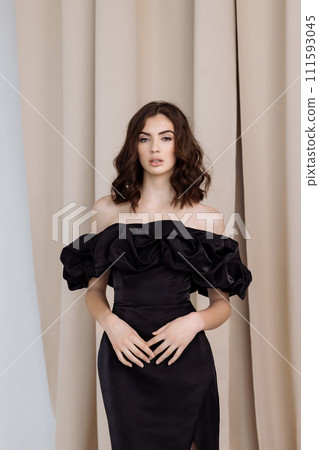A woman in a black dress poses. A woman in a black dress poses. 111593045